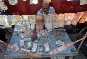 A roadside currency exchange vendor sorts Indian currency notes at his stall in Agartala, India, December 6, 2016. REUTERS/Jayanta Dey
